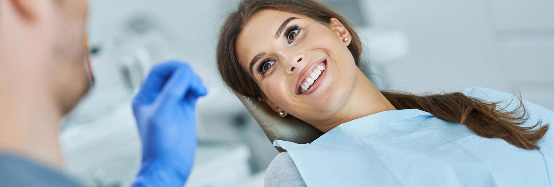 A young patient smiling during a conversation with the dentist