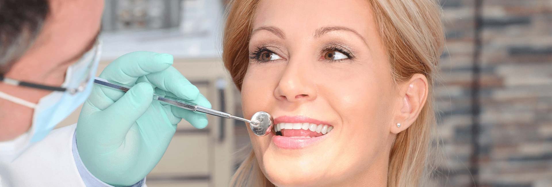 Dentist examing a women's teeth